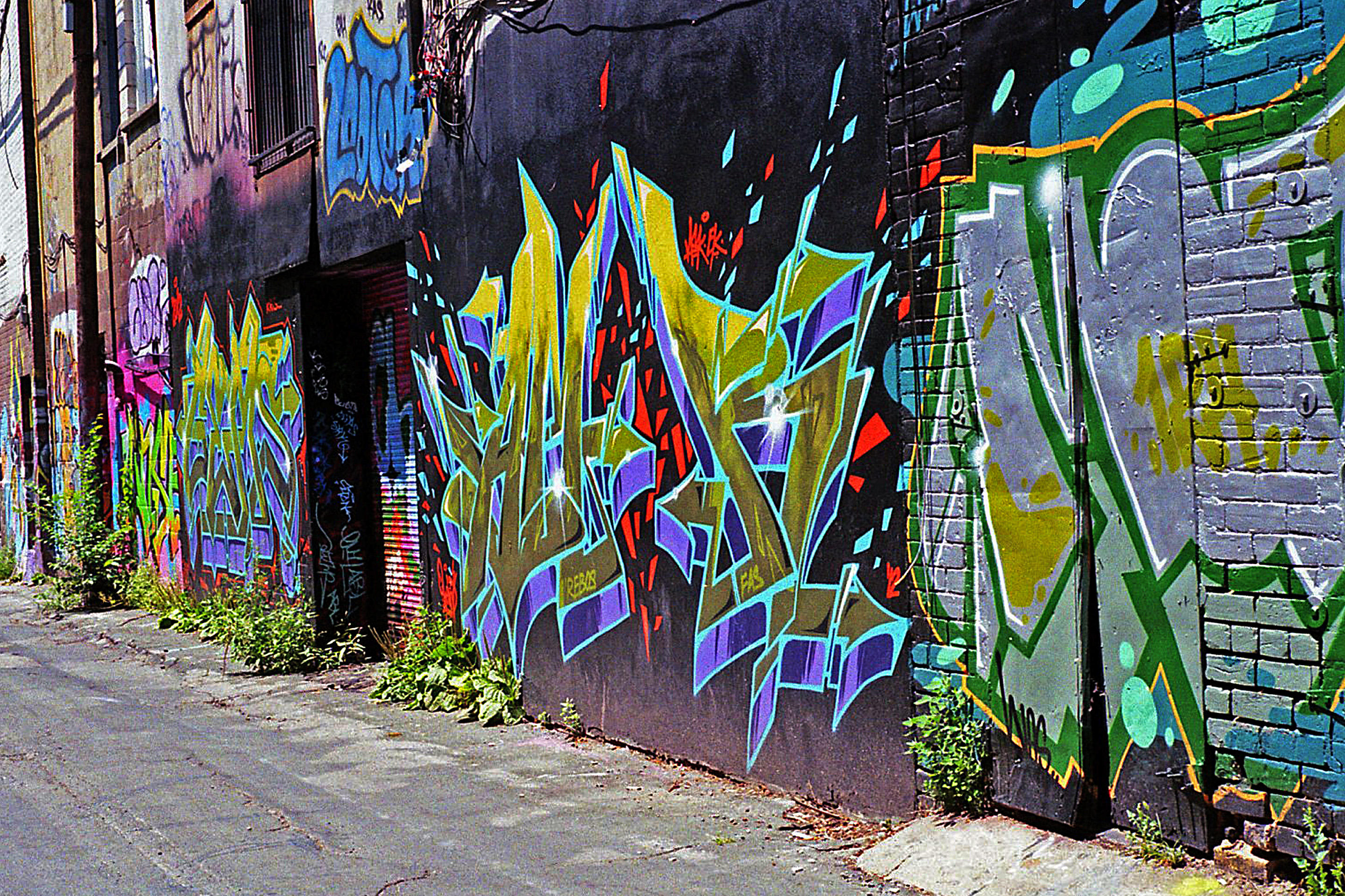 Colourful letter pieces covering the walls of Toronto's Graffiti Alley